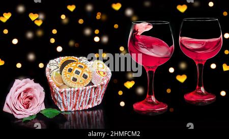 Deux verres de vin, un panier de bonbons et une rose, sur fond noir avec un bokeh en forme de coeur Banque D'Images