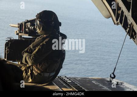 Sergent du corps des Marines des États-Unis Patrick Pearson, un chef d'équipage du CH-53E Super Stallion au sein de l'escadron de Tiltrotor Marine Medium 265 (renforcé), surveille les opérations de vol lors d'un exercice d'évacuation des non-combattants (NEO) en mer des Philippines, le 1 février 2022. Marines et marins se sont réunis pour exécuter l'EXERCICE NÉO qui traite et transporte précipitamment les évacués d'une zone d'opération. Le MEU de 31st opère à bord de navires du America Amphiobie Ready Group dans la zone d'opérations de la flotte de 7th afin d'améliorer l'interopérabilité avec les alliés et les partenaires, et de servir de force de réaction prête au def Banque D'Images