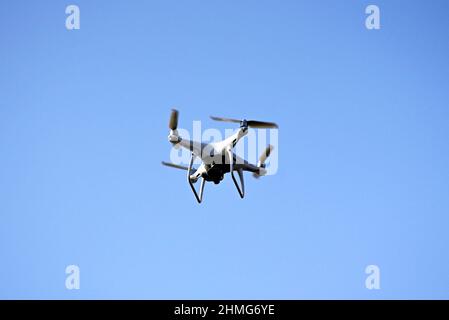 Un gros plan de drone vole contre un ciel bleu isolé Banque D'Images