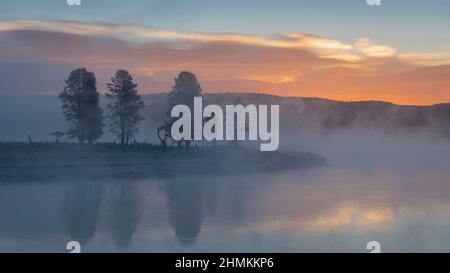 Lever de soleil brumeux sur la rivière Yellowstone dans la vallée de Hayden, parc national de Yellowstone. Banque D'Images