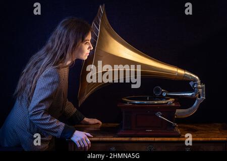 Londres, Royaume-Uni. 11 février 2022. Un membre du personnel pose avec “Un Gramophone & Typwriter Ltd Senior Monarch Horn Gramophone”, vers 1907 (est. £700 - 1 000 £). Aperçu de la vente de la Bibliothèque Connoisseur qui aura lieu à la salle de vente Bonhams Knightsbridge les 15 et 16 février. Credit: Stephen Chung / Alamy Live News Banque D'Images