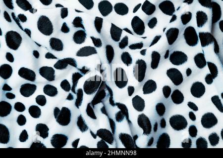 gros plan d'un tissu imprimé animal noir et blanc, à utiliser comme arrière-plan Banque D'Images