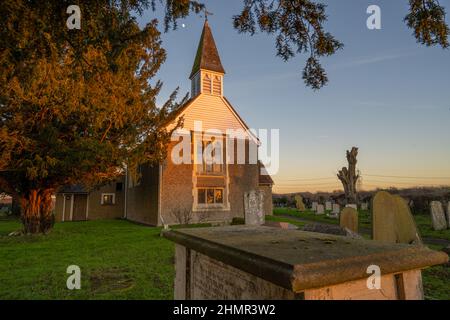 La lune au-dessus de l'église Saint-Margare Ifield près de Gravesend au coucher du soleil en hiver Banque D'Images