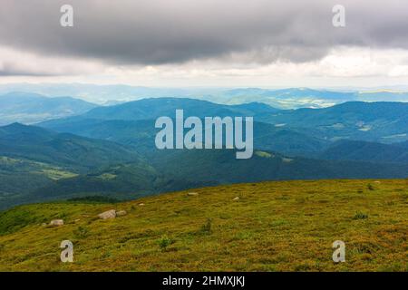 paysage de montagne par jour nuageux. nuages orageux au-dessus des sommets et des vallées de transcarpathia. paysage d'été avec prairies verdoyantes Banque D'Images