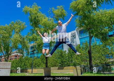 Un jeune couple latin sautant tranquillement dans un parc. Concept de bonheur, couple, amour, Banque D'Images