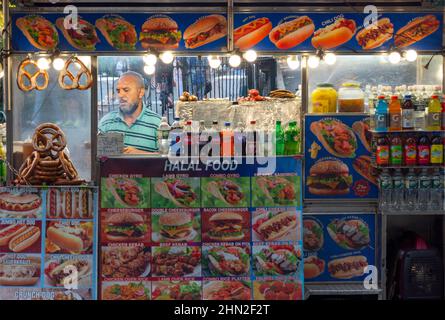 Homme dans un fournisseur de chariots alimentaires halal dans le bas de Manhattan, New York Banque D'Images