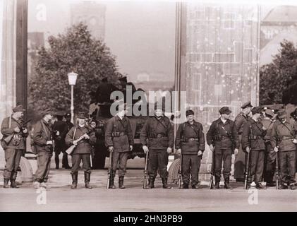 Photo d'époque de la crise de Berlin de 1961: Construire le mur A Squad de la Milice des travailleurs de Berlin est avec des canons de sous-machines tient épaule-à-épaule i Banque D'Images