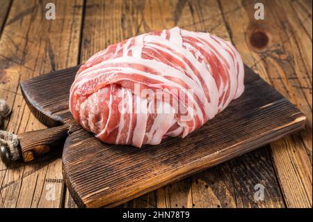 Pain de viande cru avec viande hachée et bacon avec herbes et épices sur planche à découper en bois. Arrière-plan en bois. Vue de dessus Banque D'Images