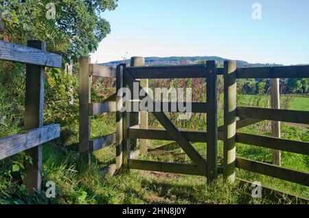 Petite porte traditionnelle en bois sur le sentier menant au champ dans la vallée des terres agricoles, Tayside, Perthshire, Écosse Royaume-Uni, temps ensoleillé, début de l'automne. Banque D'Images