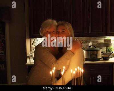 Grand-mère et petite-fille célébrant leurs anniversaires mutuels dans un cadre lumineux discret et s'embrassant les uns les autres. Partager un anniversaire à 60 ans d'intervalle. Banque D'Images