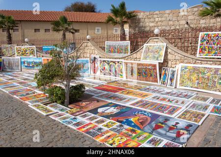 Peintures locales à vendre sur la rue piétonne en front de mer, Rua Kuamen'Kruma, Santa Maria, Sal, República de Cabo (Cap-Vert) Banque D'Images