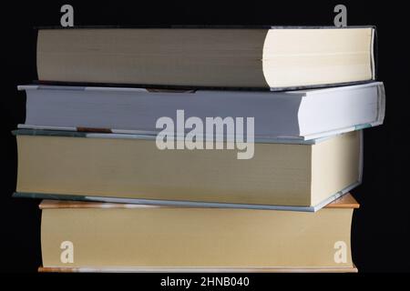 Livres de côté sur une table avec un arrière-plan sombre Banque D'Images