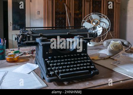 Février 2022, bureau abandonné avec une machine à écrire antique, Urbex dans le nord de l'Italie Banque D'Images