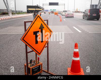 les panneaux répare la route et le travailleur sur la route Banque D'Images