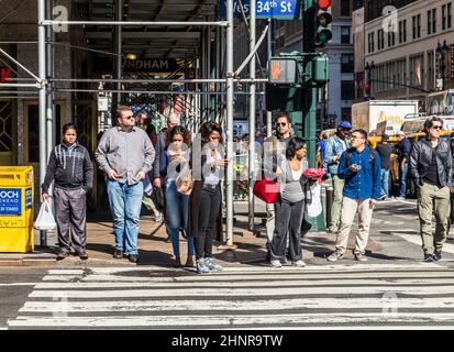 Les gens près de Wall Street à Manhattan traversent la rue au feu blanc Banque D'Images