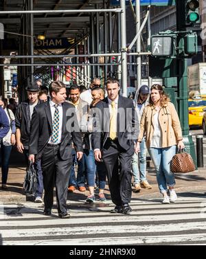 Les gens près de Wall Street à Manhattan traversent la rue au feu blanc Banque D'Images