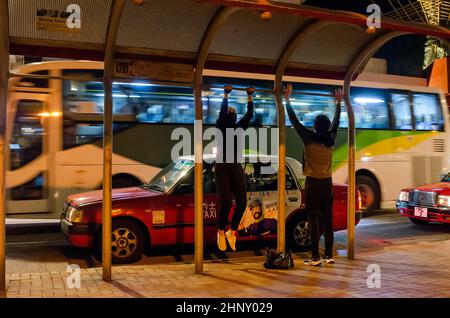 Personnes portant des masques et faisant de l'exercice comme protection contre le coronavirus de propagation, 2022, Hong Kong, Chine. Banque D'Images