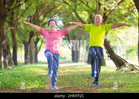 Couple senior heureux s'exerçant dans le parc Banque D'Images