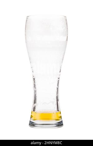 Tall beer glass almost full with lager beer, in the process of drinking. Someone already took a sip from the glass. Isolated on white Stock Photo