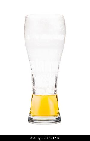 Tall beer glass almost full with lager beer, in the process of drinking. Someone already took a sip from the glass. Isolated on white Stock Photo