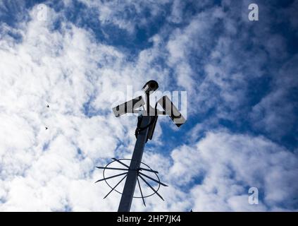 Caméras CCTV sur un lampadaire avec des nuages derrière elles à la gare de Maidstone East, Kent, Royaume-Uni. Banque D'Images