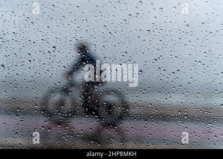 Salvador, Bahia, Brésil - 15 novembre 2021 : une personne à vélo sous la pluie.Salvador, Bahia, Brésil. Banque D'Images