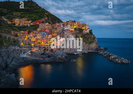 Un des plus célèbres village de pêcheurs du monde avec des maisons de bord de mer colorées sur les falaises le soir, Manarola, Cinque Terre, Ligurie, Italie, EUR Banque D'Images