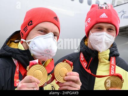 21 février 2022, Hessen, Francfort-sur-le-main : Francesco Friedrich (l) et Alexander Schüller, bobsledders et médaillés d'or dans le bobsleigh de quatre hommes, présentent leurs médailles d'or à l'aéroport de Francfort au retour de l'équipe allemande des Jeux Olympiques de Beijing. Photo: Arne Dedert/dpa Banque D'Images