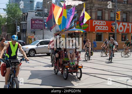 Drapeaux de fierté gais, en cuir, bisexuels et non binaires agitant sur le flotteur à travers Church Street. Défilé de fierté gay flottent à Toronto, Ontario Canada. Banque D'Images