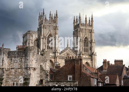 L'église York minster surplombe les rues et les toits de la ville avec des nuages orageux et un ciel spectaculaire. Banque D'Images