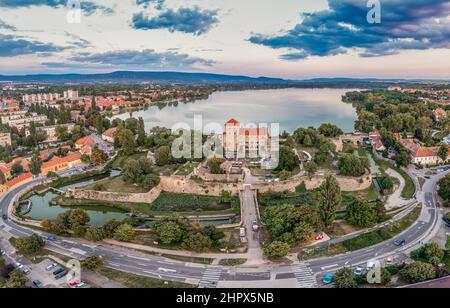 Vue aérienne au coucher du soleil sur le vieux lac de Tata avec château médiéval entouré de douves, bastions et murs en Hongrie Banque D'Images