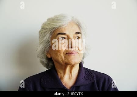 Seventies, people, old age, older woman sitting in an armchair