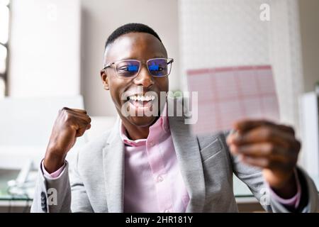 Happy Man à la recherche d'un billet de loterie gagnant Banque D'Images