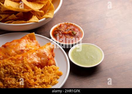 Une paire d'Enchiladas avec sauce rouge et riz assaisonné Banque D'Images