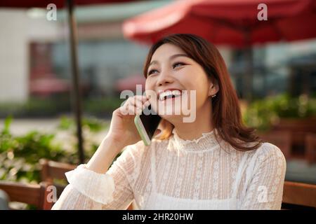 Un coup d'un Asian Woman talking on the phone Banque D'Images