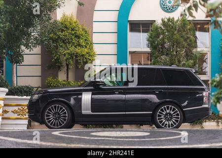 Side, Turquie - 02 février 2022 : le Range Rover noir est stationné dans la rue par une chaude journée sur fond de parc construit Banque D'Images