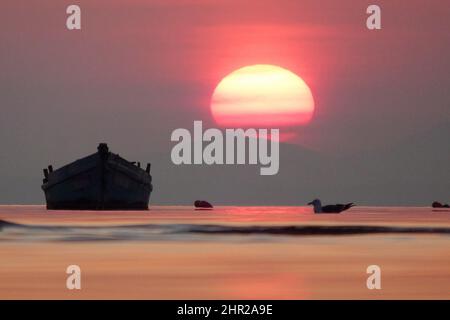 YANTAI, CHINE - 8 FÉVRIER 2022 - lever du soleil sur la mer à Yantai, province de Shandong en Chine orientale, 8 février 2022. Banque D'Images