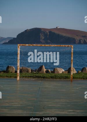 Appâts, Galice, Espagne. Vue verticale du terrain de football avec l'océan Atlantique et une île avec un phare en arrière-plan. Banque D'Images