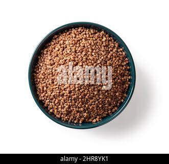 Gruaux de sarrasin biologique cru dans un bol en céramique bleu isolé sur fond blanc. Grains de sarrasin rôtis pour une alimentation végétarienne saine. Sans gluten. Banque D'Images