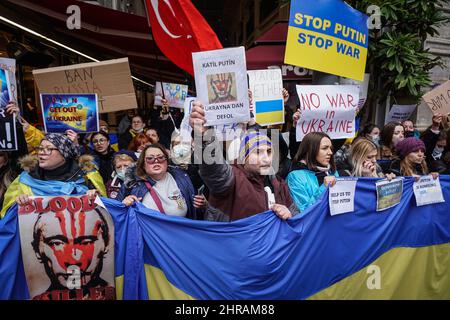 Istanbul, Turquie. 25th févr. 2022. Les manifestants tiennent des pancartes et un immense drapeau ukrainien pendant la manifestation.des citoyens ukrainiens vivant à Istanbul se sont rassemblés devant le consulat général russe dans le district de Beyo?lu et ont protesté contre l'opération militaire russe contre l'Ukraine. Criant des slogans « Killer Poutine » et tenant des bannières « No to war » et « Stop the war », les manifestants ont appelé à l'arrêt de la guerre Dès que possible pendant que la police a pris des mesures de sécurité étendues, certains Ukrainiens ont éclaté en larmes. (Photo par Ibrahim Oner/SOPA Images/Sipa USA) crédit: SIPA USA/Alay Live News Banque D'Images