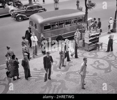 1930S 1940S PIÉTONS DEBOUT SUR L'AVENIDA RIO BRANCO MOSAÏQUE TROTTOIR QUARTIER DES AFFAIRES KIOSQUE AUTOBUS RIO DE JANEIRO BRÉSIL - R12249 PAL001 HARS B&W AMÉRIQUE DU SUD HAUT ANGLE SERVICE À LA CLIENTÈLE AUTOS PROGRESS KIOSQUE À JOURNAUX SUR RIO CONCEPTUAL AUTOMOBILES BRÉSIL STYLISÉ VÉHICULES AVENIDA MOSAÏQUE MAJEURE RIO DE JANEIRO TOGETHERNESS QUARTIER NOIR ET BLANC ANCIEN MODE Banque D'Images