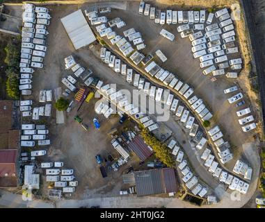 Vue de drone sur les véhicules de loisirs blancs garés dans un parc avec des structures par jour d'été Banque D'Images