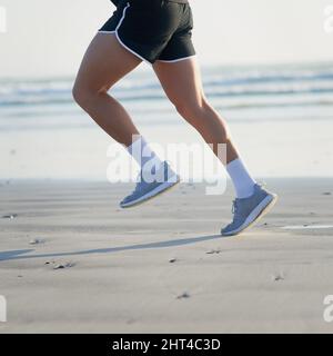 Ne vous arrêtez pas jusqu'à ce que vous ayez atteint votre objectif. Photo courte d'un jeune homme méconnu qui court sur la plage. Banque D'Images
