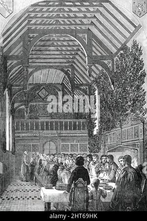 Célébration du dimanche des palmiers dans la salle du Sackville College, East Grinstead, [Sussex]. 1850. 'Cette salle, jusqu'à récemment utilisée comme un sellerie, est une grande salle avec un toit ouvert en chêne de trois baies, la partie inférieure lambrissée de chêne foncé, Et ayant une galerie du même matériel à l'extrémité ouest les murs sont ornés de... boucliers portant les bras des différentes branches de la famille Dorset. Une grande cheminée ouverte, avec un feu de bois flamboyant, est d'un côté; en travers de l'extrémité supérieure et en bas du centre est placé une grande table en chêne. Autour de cela ont été recueillies les habitants âgés du village, Banque D'Images