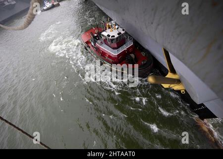 Un remorqueur manœuvre l'USS Gerald R. Ford (CVN 78) dans la rivière James pendant un détail de mer et d'ancre, 25 février 2021. Ford est en cours dans l'océan Atlantique après avoir terminé la partie industrielle d'une disponibilité incrémentielle prévue (ÉFVP) de six mois. (É.-U. Photo de la marine par le spécialiste des communications de masse 3rd classe Zack Guth) Banque D'Images