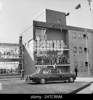 West Cumberland Hospital, Homewood Road, Homewood, Whitehaven, Copeland, Cumbria, 21/10/1964. Le personnel de l'hôpital croque des balcons à l'hôpital de West Cumberland pour déferrer la reine mère alors qu'elle part dans sa voiture officielle après la cérémonie d'ouverture. Banque D'Images