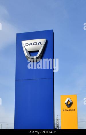 Pontypridd, pays de Galles - février 2022 : panneaux à l'extérieur d'une salle d'exposition de voitures Dacia et Renault isolée contre un ciel bleu. Personne. Banque D'Images