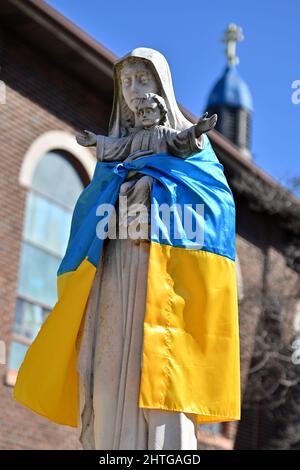 Pittston, États-Unis. 28th févr. 2022. Le drapeau de l'Ukraine a été attaché autour d'une statue de la Vierge Marie et de Jésus-Christ à l'extérieur de l'église Saint-Michel. Crédit : SOPA Images Limited/Alamy Live News Banque D'Images