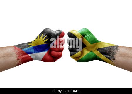 Deux mains poinçonner l'une à l'autre sur fond blanc. Les drapeaux de pays ont peint des poings, le concept de crise de conflit entre antigua-et-barbuda et la jamaïque Banque D'Images