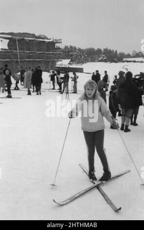 Photographie vintage authentique des années 60 de la jeune femme sur le ski avec des bâtons de ski regardant l'appareil photo, Suède Banque D'Images